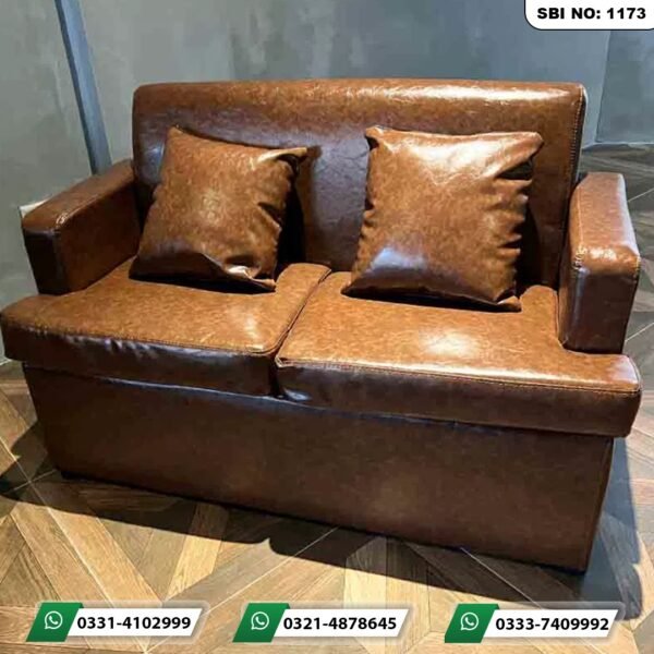 Premium cafe sofa Pakistan featuring a 2-seater brown textured leather sofa with matching cushions by Saqib Baba Interiors.