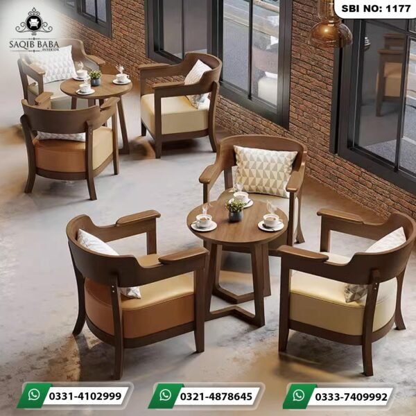 Coffee shop furniture Pakistan with wooden armchairs, round tables, and patterned cushions by Saqib Baba Interiors.