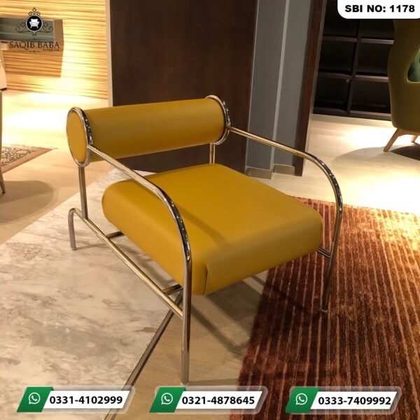 Modern executive office chairs Pakistan featuring a mustard yellow leather armchair with chrome steel frame by Saqib Baba Interiors.