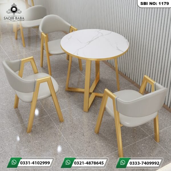 Modern luxury round marble cafe set with off white leatherette gold frame chairs and a round marble top table by Saqib Baba Interior