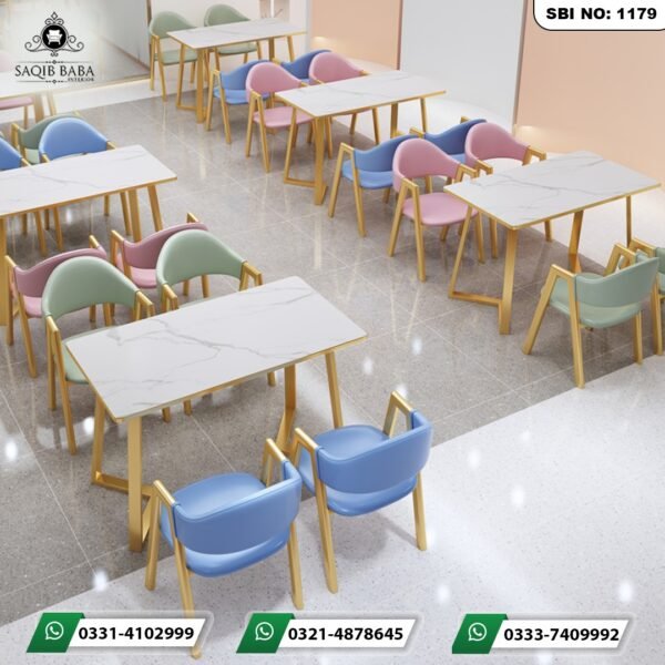 Modern restaurant tables price in Pakistan with white marble tops and colorful pastel chairs by Saqib Baba Interiors.