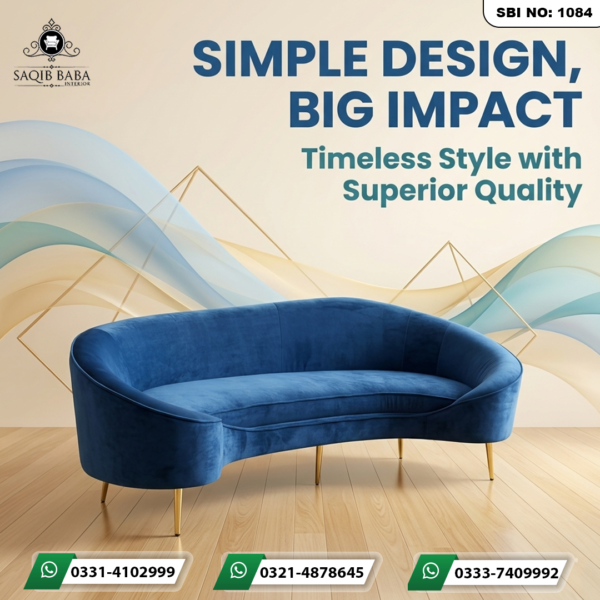 "A modern royal blue velvet curved sofa with slim gold metallic legs by Saqib Baba Interior, set against a light wood floor and abstract background."