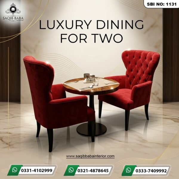 A pair of high-back red velvet tufted wing chairs with a circular dark wood pedestal dining table in a luxury marble setting.