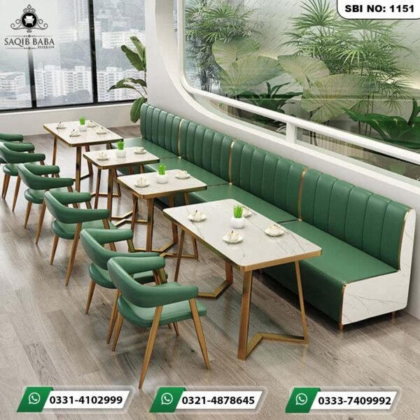 Premium green commercial cafe booth seating sofas with white marble side panels and gold metal trims by Saqib Baba Interior.