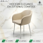 Cream-colored modern accent chair with sleek silver chrome legs and curved backrest, displayed in a luxury marble setting.