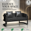 Contemporary black two-seater sofa with a matte black metal frame and matching cushions, placed against a luxury marble and wood-paneled background.