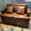 Premium cafe sofa Pakistan featuring a 2-seater brown textured leather sofa with matching cushions by Saqib Baba Interiors.