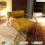 Modern executive office chairs Pakistan featuring a mustard yellow leather armchair with chrome steel frame by Saqib Baba Interiors.