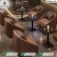Luxury gold cafe dining set with green leather padded chairs and white marble top tables by Saqib Baba Interior