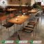 Commercial restaurant table Pakistan with a wooden top and star-shaped steel metal base by Saqib Baba Interiors.