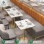 Luxury dual tone restaurant booth seating set with orange and grey leatherette benches matching chairs and marble top tables by Saqib Baba Interior