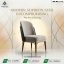 A luxury dining chair featuring a light grey velvet front, black leather back, and wooden legs with gold metal accents.