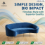 "A modern royal blue velvet curved sofa with slim gold metallic legs by Saqib Baba Interior, set against a light wood floor and abstract background."